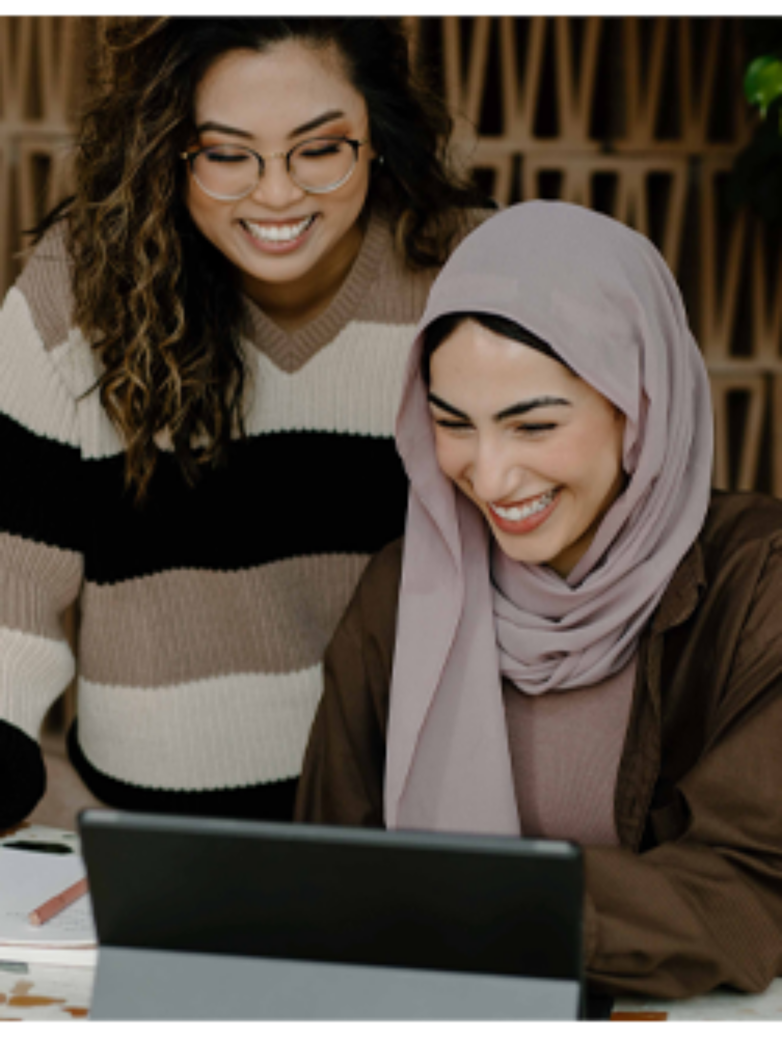 Two women working on a laptop
